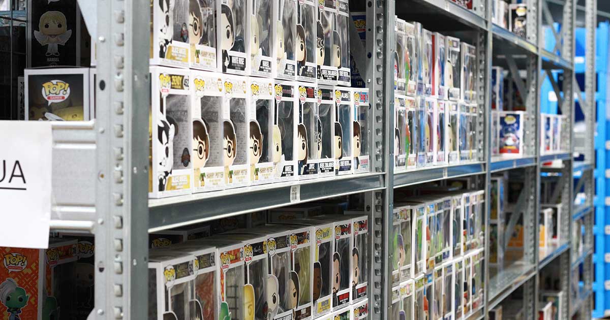  Shelves stocked with boxed collectible figurines in a store.