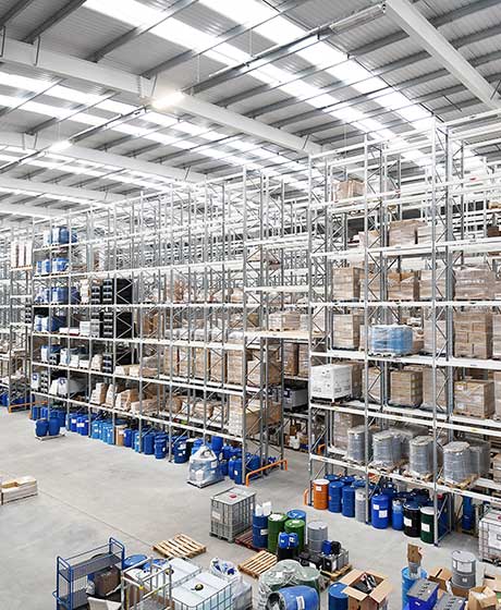 Large warehouse interior with high shelves stocked with various goods.